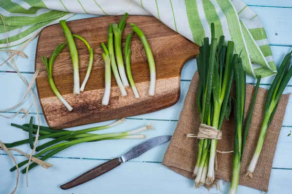 Fresh spring onion bunch on wooden table — Stock Photo, Image