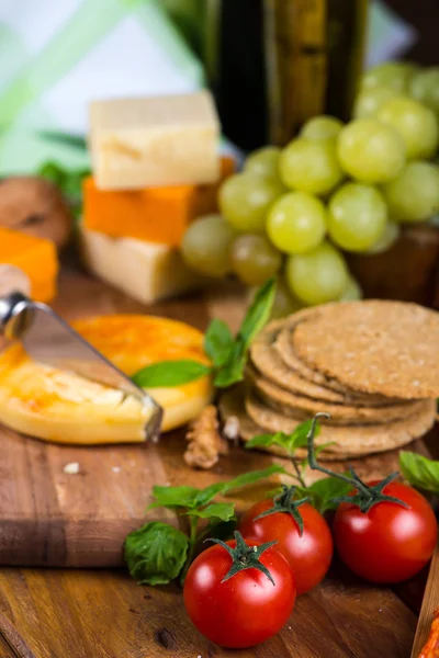 Cheese with fork on wooden board — Stock Photo, Image