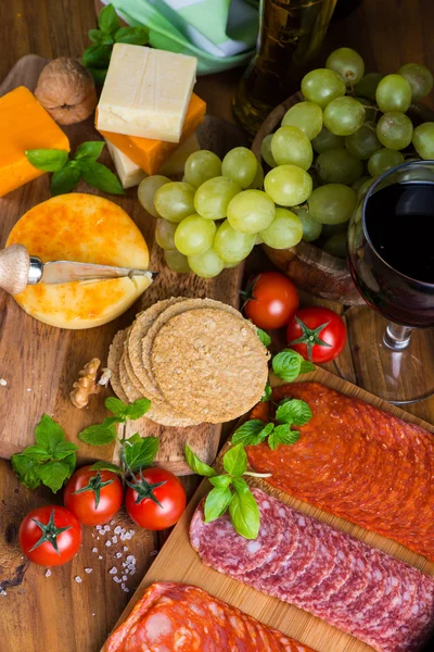 Overhead view on antipasti with cheese salami ham red wine and g — Stock Photo, Image
