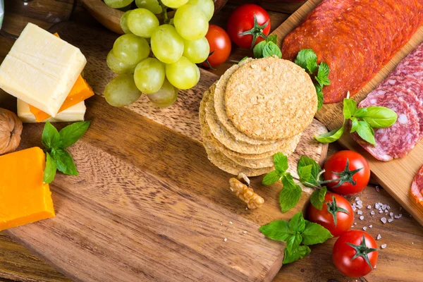 Overhead view on antipasti with cheese salami ham red wine and g — Stock Photo, Image