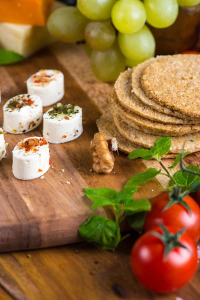 Selection of soft cheese with fruits, spices and meat — Stock Photo, Image