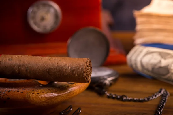 Rich person desk with cuban cigar, dollar notes and expensive wa — Stock Photo, Image