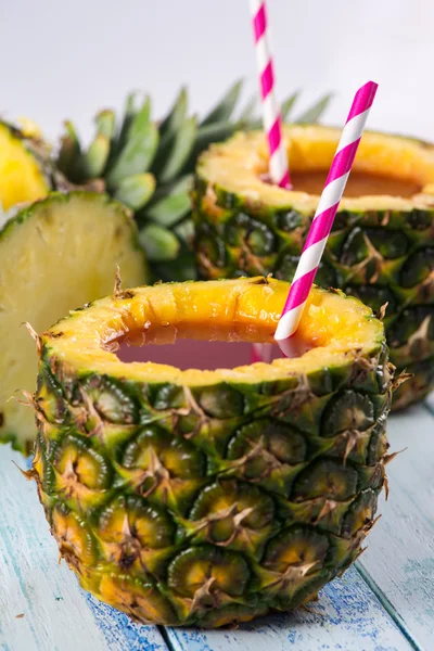 Exotic fresh fruit juice into pineapple with straw — Stock Photo, Image