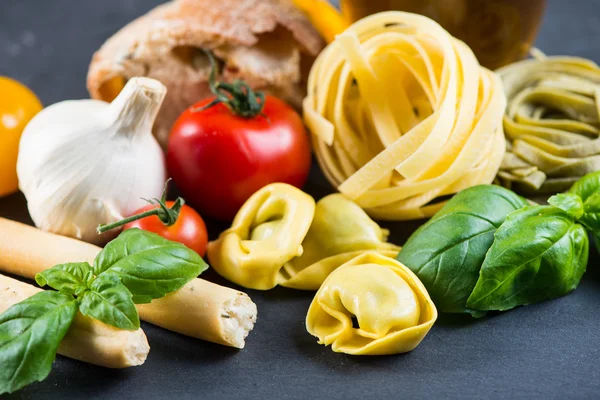 Selection of italian tipical food on black background