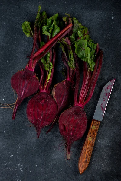 Farm fresh beetroots cut in half on dark background — Stock Photo, Image