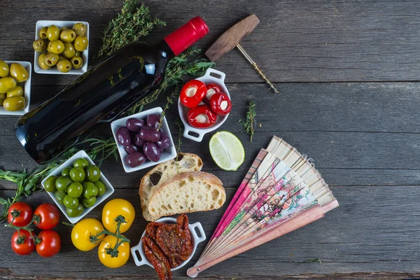 Traditional tapas buffet on wooden table from above — Stock Photo, Image