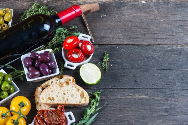 Traditional tapas buffet on wooden table from above — Stock Photo, Image