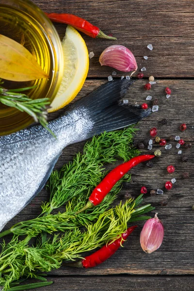 Fresh whole sea fish with aromatic herbs and spices — Stock Photo, Image