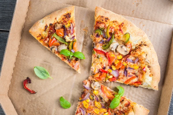 Scheiben hausgemachte vegetarische Pizza im Karton — Stockfoto
