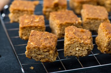 Homemade healthy flapjacks with honey on cooling rack clipart