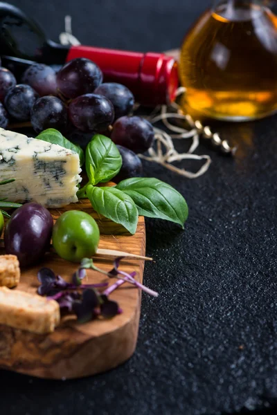 Food background,rustic board with cheese herbs and wine — Stock Photo, Image