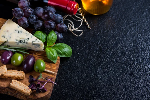 Food background,rustic board with cheese herbs and wine — Stock Photo, Image