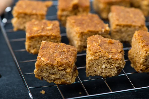 Homemade healthy flapjacks with honey on cooling rack — Stock Photo, Image