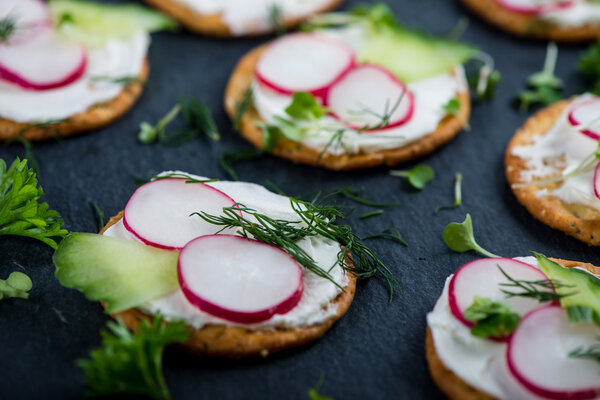 Crackers with cottage cheese, radish, cucumber decorated with cr