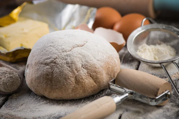 Baking on rustic table, dough and ingredients — Stock Photo, Image