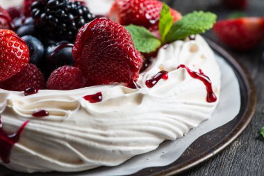 Homemade pavlova meringue with summer fresh berries clipart
