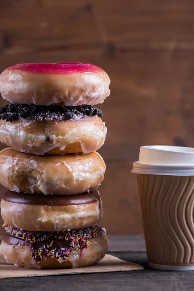 Stack of fresh artisan donuts and take away coffee — Stock Photo, Image