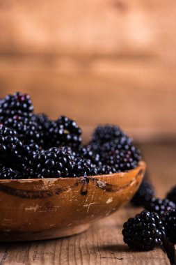 Fresh ripe blackberry in rustic bowl