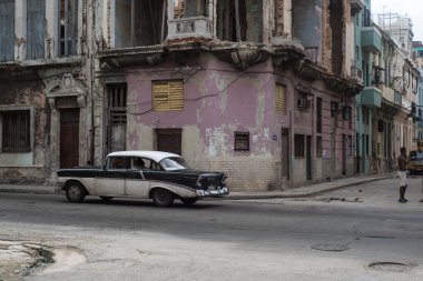 Cuban street scene with people and classic car