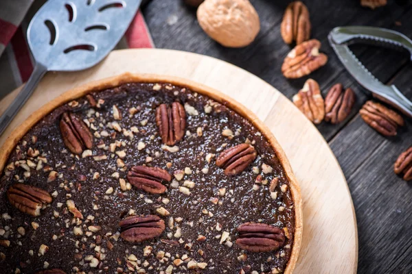 Pecan pie, nut crusher on table — Stock Photo, Image