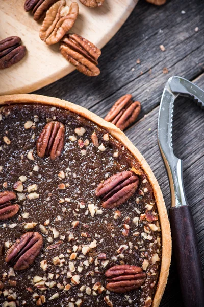 Pecan pie, nut crusher on table — Stock Photo, Image