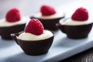 Krem ve ahududu dolu koyu çikolata Kupası