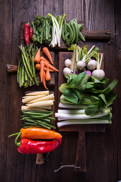 Fresh vegetables on cutting rustic boards — Stock Photo, Image