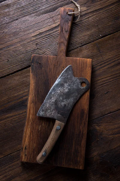 Hand vintage meat axe on wooden board — Stock Photo, Image
