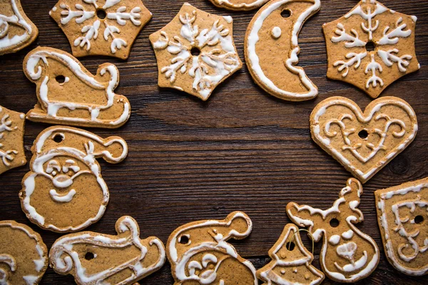 Gingerbread cookies over wooden backgroun — Stock Photo, Image