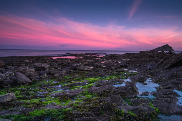 Rotsachtig strand bij avondschemering — Stockfoto