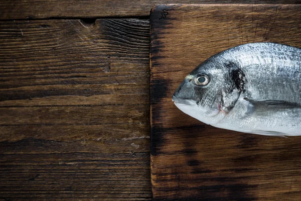 Whole fish, on wooden background — Stock Photo, Image