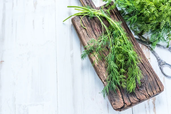 Fresh dill on cutting board — Stock Photo, Image