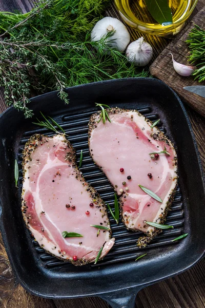 Frying pork lion steaks on pan, with herbs — Stock Photo, Image