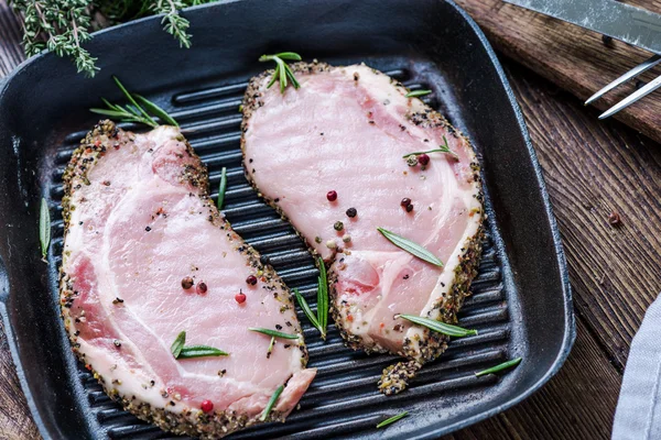 Frying pork lion steaks on pan, with herbs — Stock Photo, Image