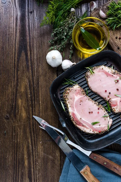 Raw pork lion chop on frying pan — Stock Photo, Image