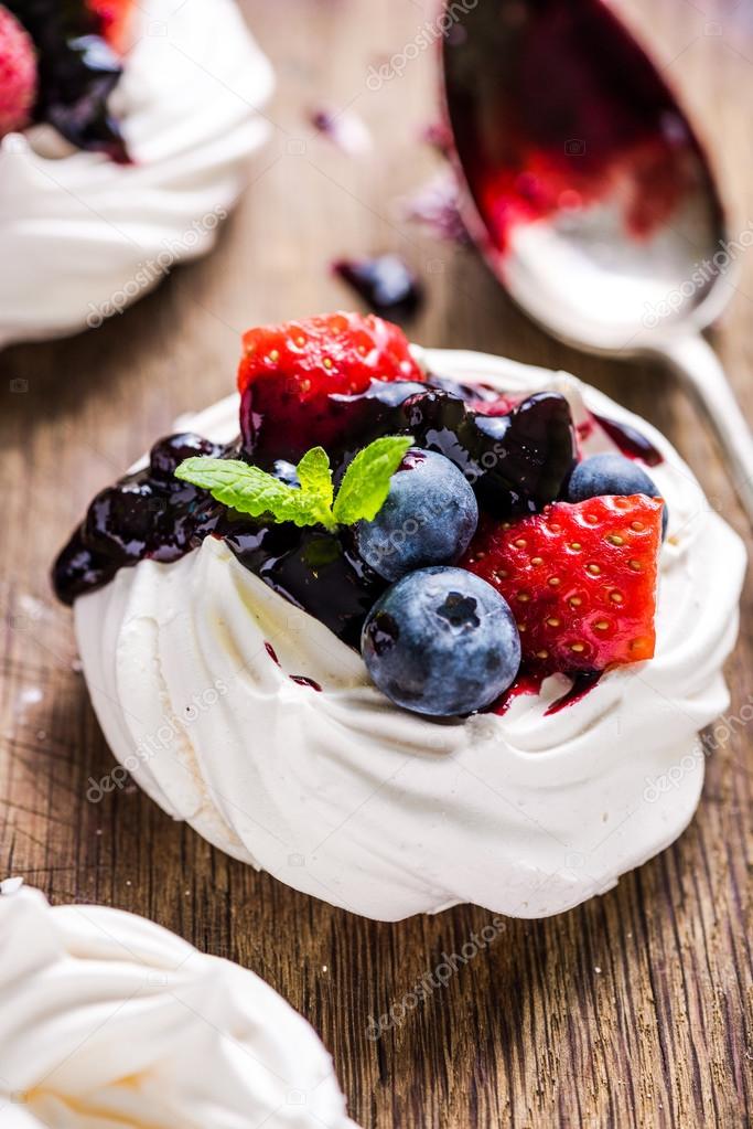 Close view on Pavlova decorated with berry fruits