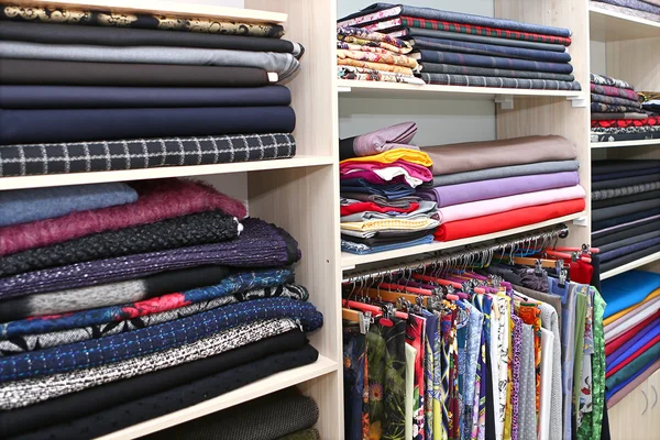 Shelves with fabric in fashion house — Stock Photo, Image