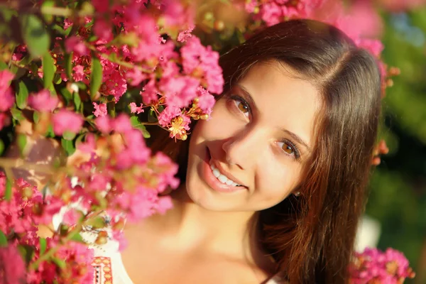 Young beautiful woman in flowers — Stock Photo, Image