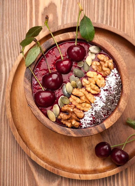 Bowl smoothie with cherry, chia seeds, pumpkin seeds and nuts