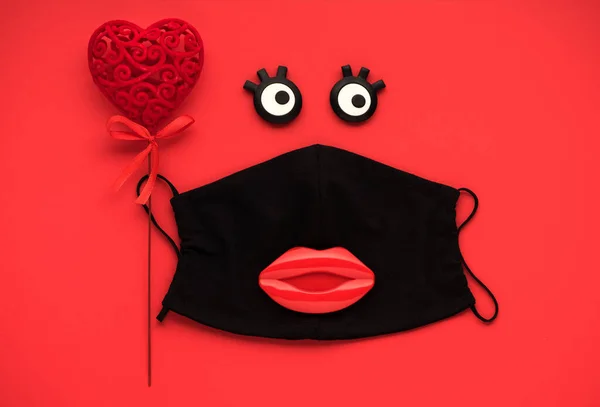 Red heart and lips with medical protection mask on red background, top view, flat lay. Creative Concept of love, valentine\'s day, healthcare, protection