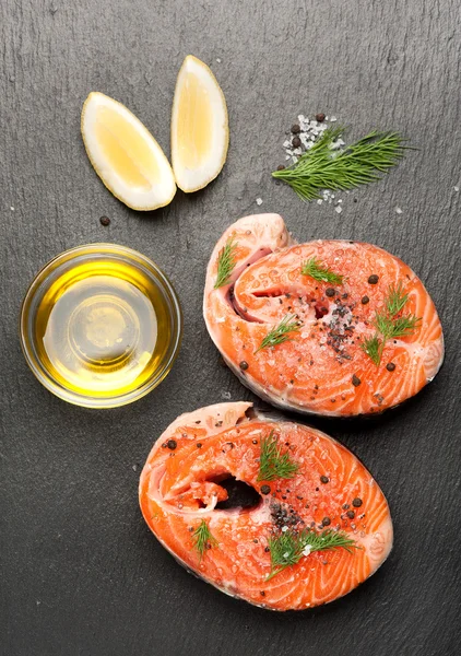 Fresh fish salmon with salt, dill and lemon. Top view.