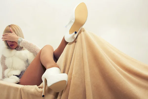 Sexy blond woman lying on armchair — Stock Photo, Image