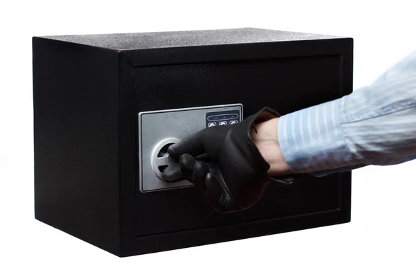 Man's hand in a striped shirt and black gloves breaking a safe, isolated on white. Small home or hotel safe — Stock Photo, Image