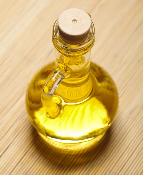 Olive oil and sticks on the wooden background — Stock Photo, Image