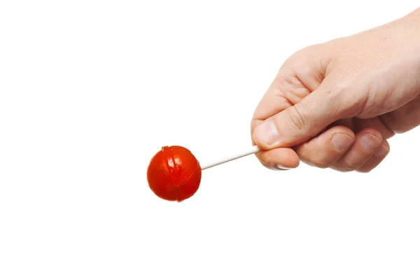Caramelo redondo rojo en mano aislado en blanco —  Fotos de Stock