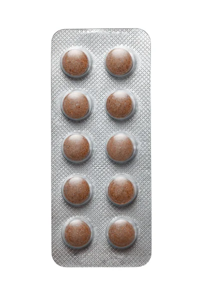 Braune Tabletten in Verpackung auf weißem Hintergrund — Stockfoto