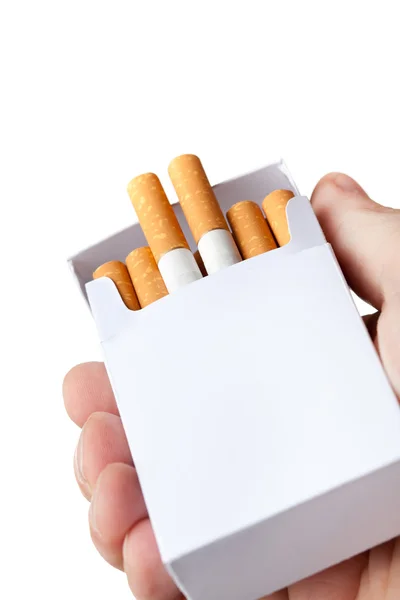 Pack of cigarettes in hand, isolated on white background — Stock Photo, Image