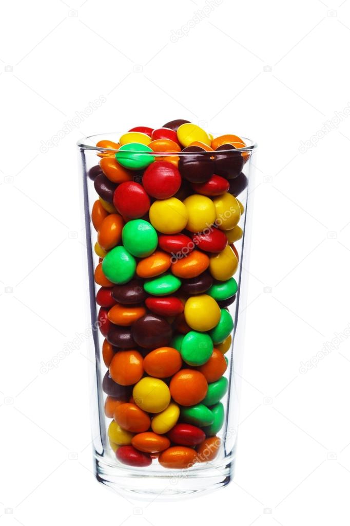 multi colored caramel sweets and chocolate candies in glass isol
