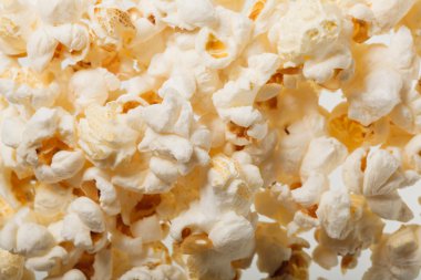 Salted popcorn grains on the white background