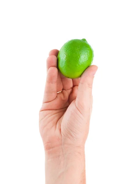 Frische saftige schmackhafte grüne Limette in einer menschlichen Hand isoliert auf einem weißen — Stockfoto